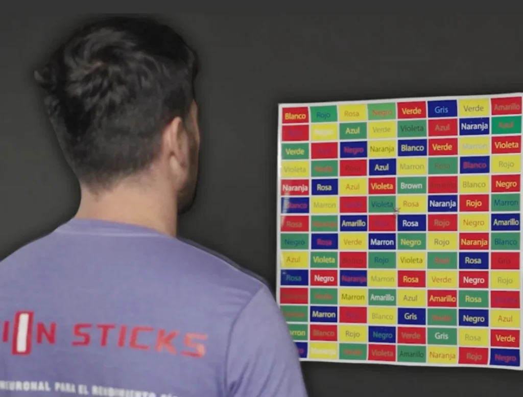 Person observing color chart with Spanish color names.